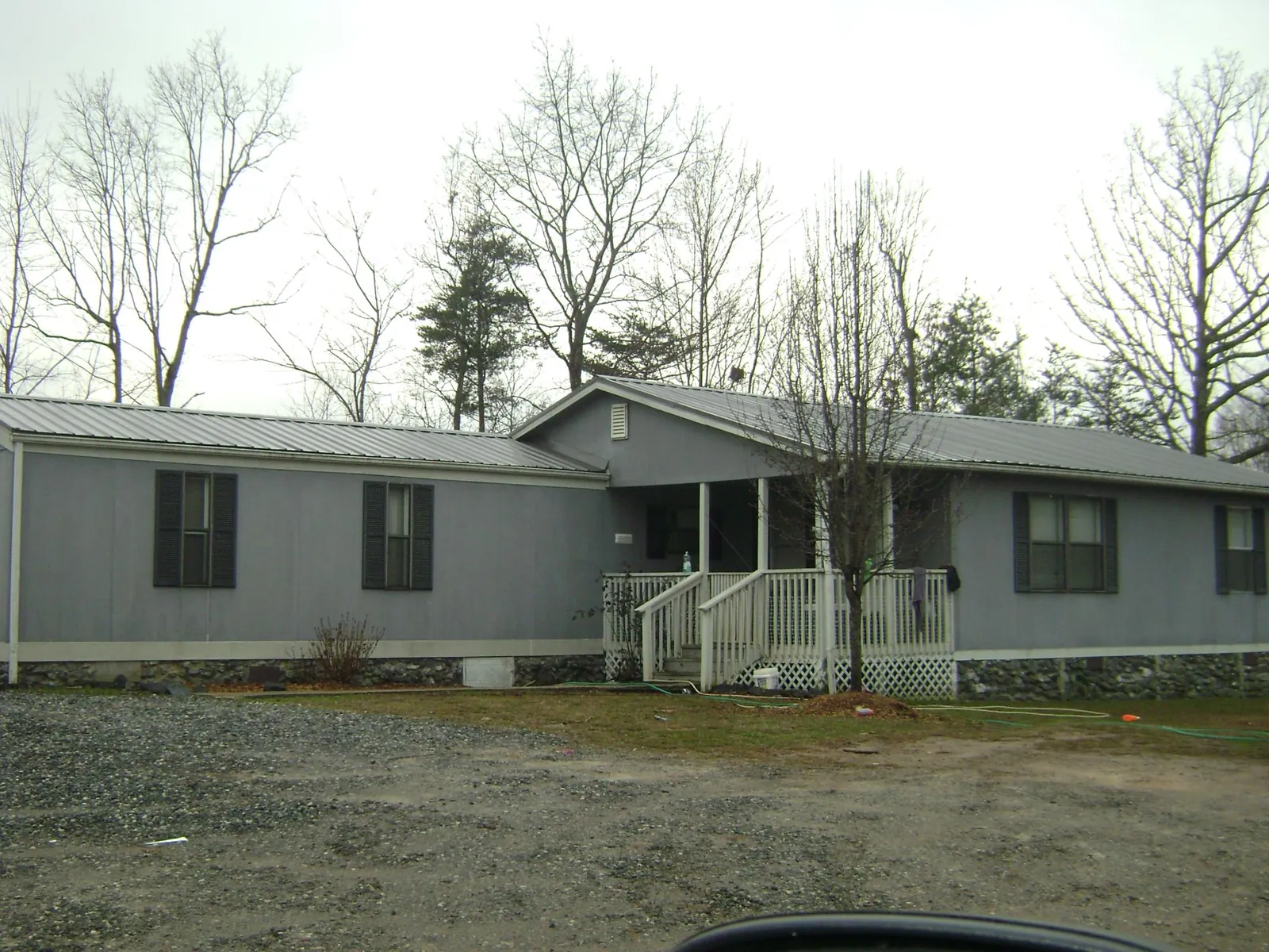 Metal roof over a manufactured home with a covered front porch in Delta